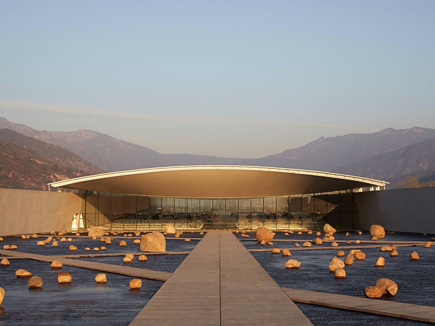 Vik Hotel Chile's curved titanium roof on a hilltop at dusk