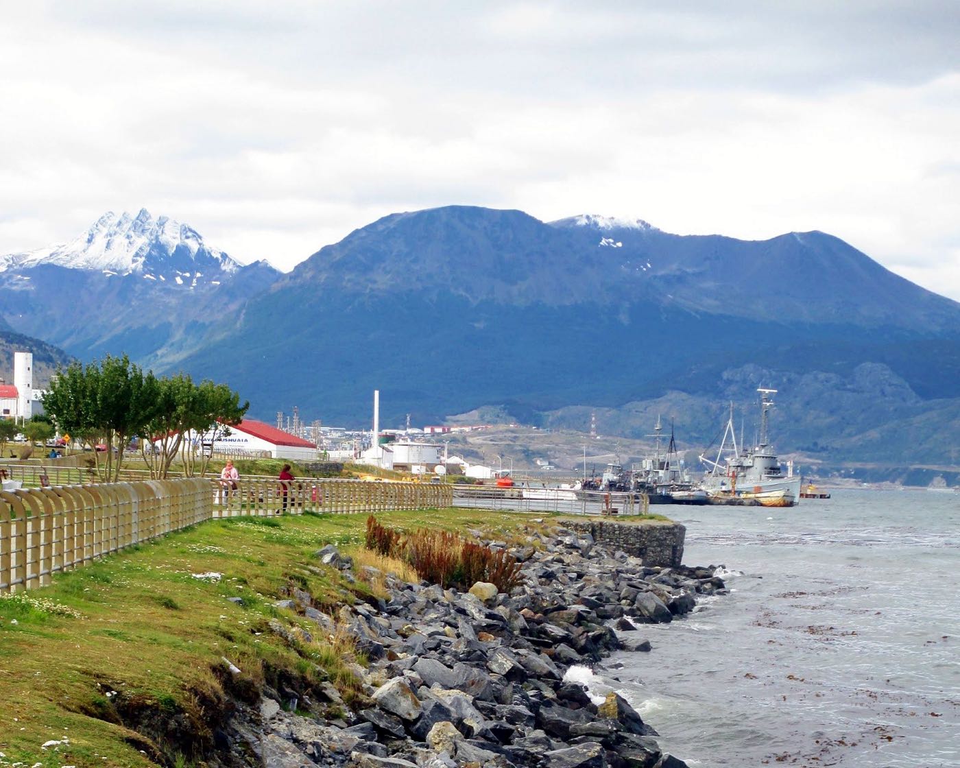 The waterfront in Ushuaia with snow-capped mountains behind the harbor