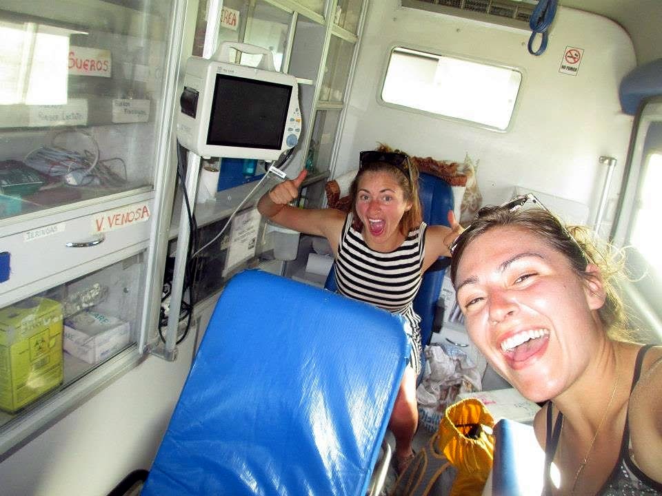 Emily and a friend laughing inside the back of an ambulance on the Carretera Austral
