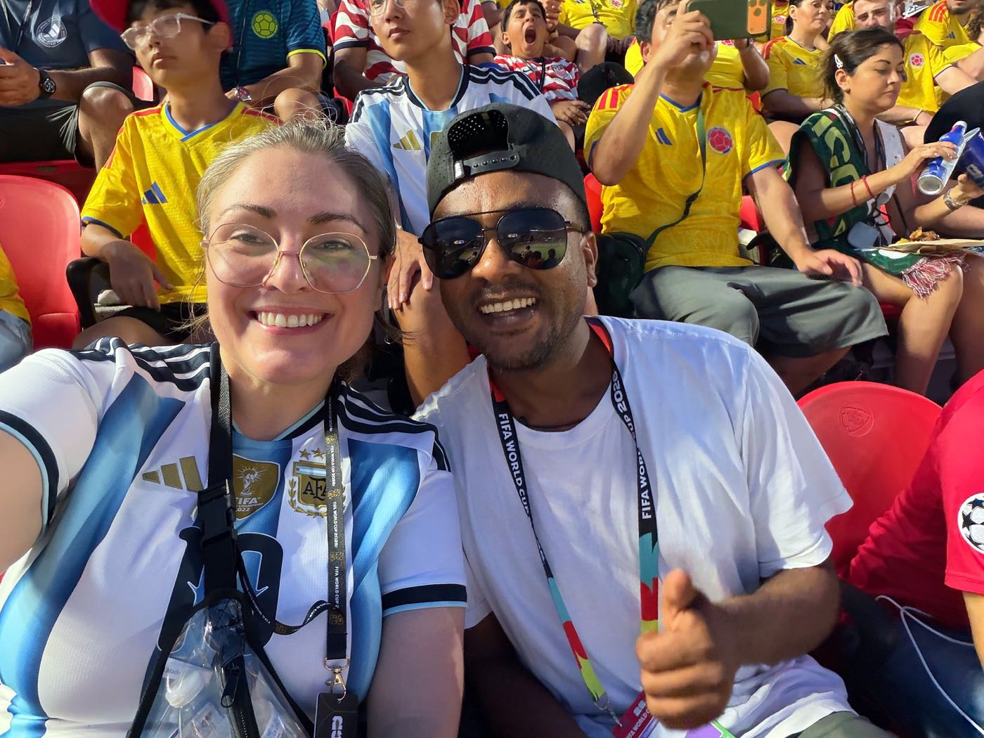 Emily in an Argentina jersey with a friend among fans in yellow at Arrowhead Stadium